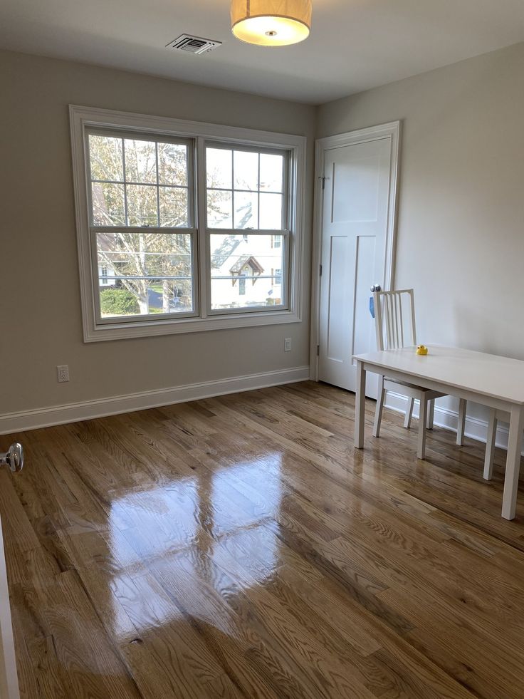 A kitchen area with a shiny wooden floor